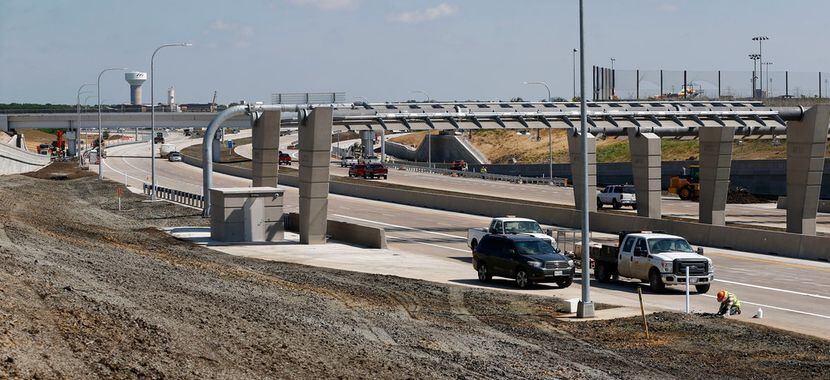 Construction workers put finishing touches on the $300 million 360 Tollway. The 9.7 miles of...