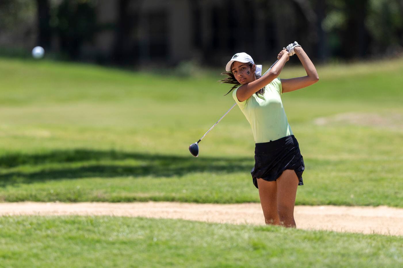 Southlake Carroll’s Alisha Choufry hits from a bunker on the 18th hole during the 6A girls...