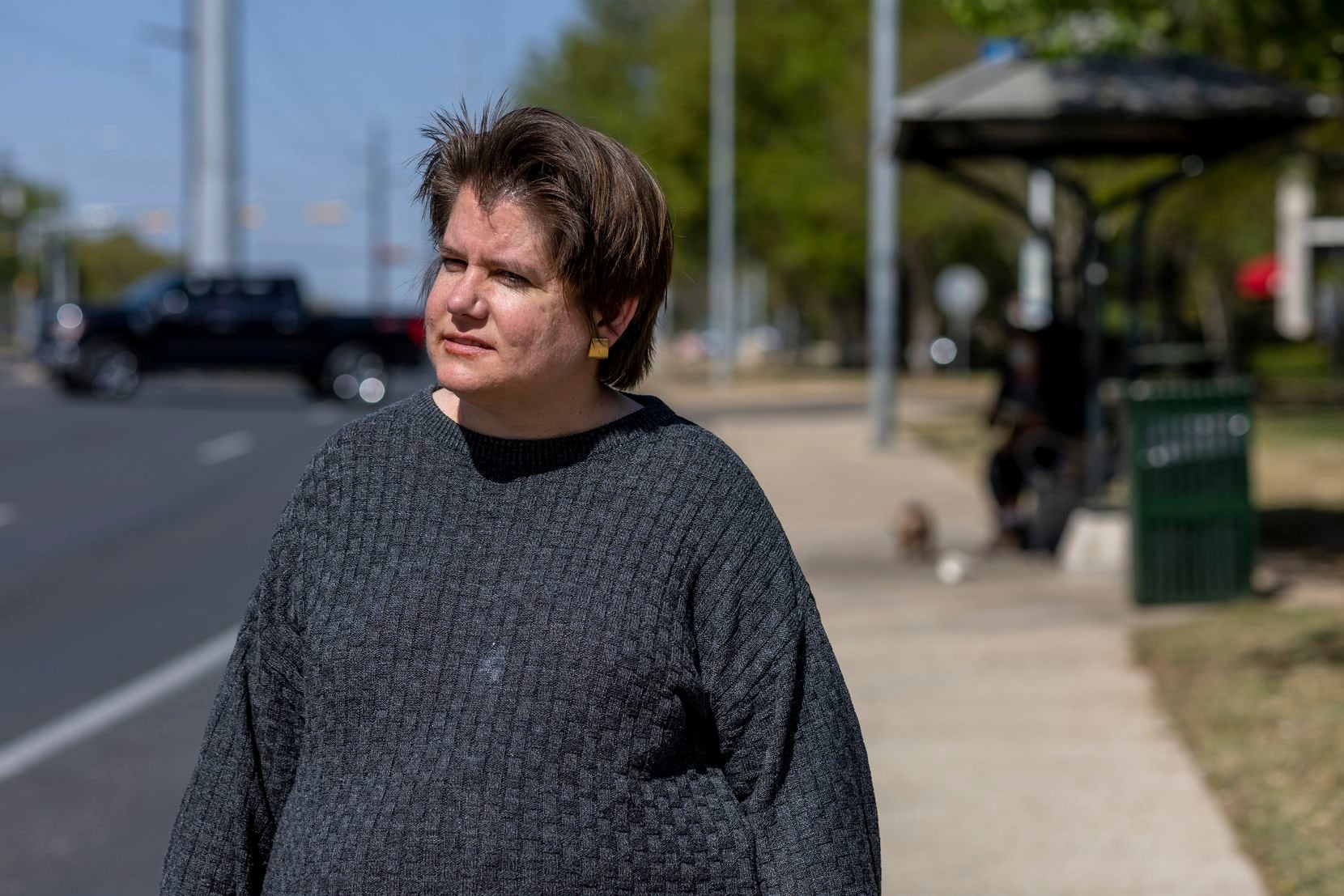 Robin Orlowski stands at a bus stop approximately a quarter of a mile from her apartment in...