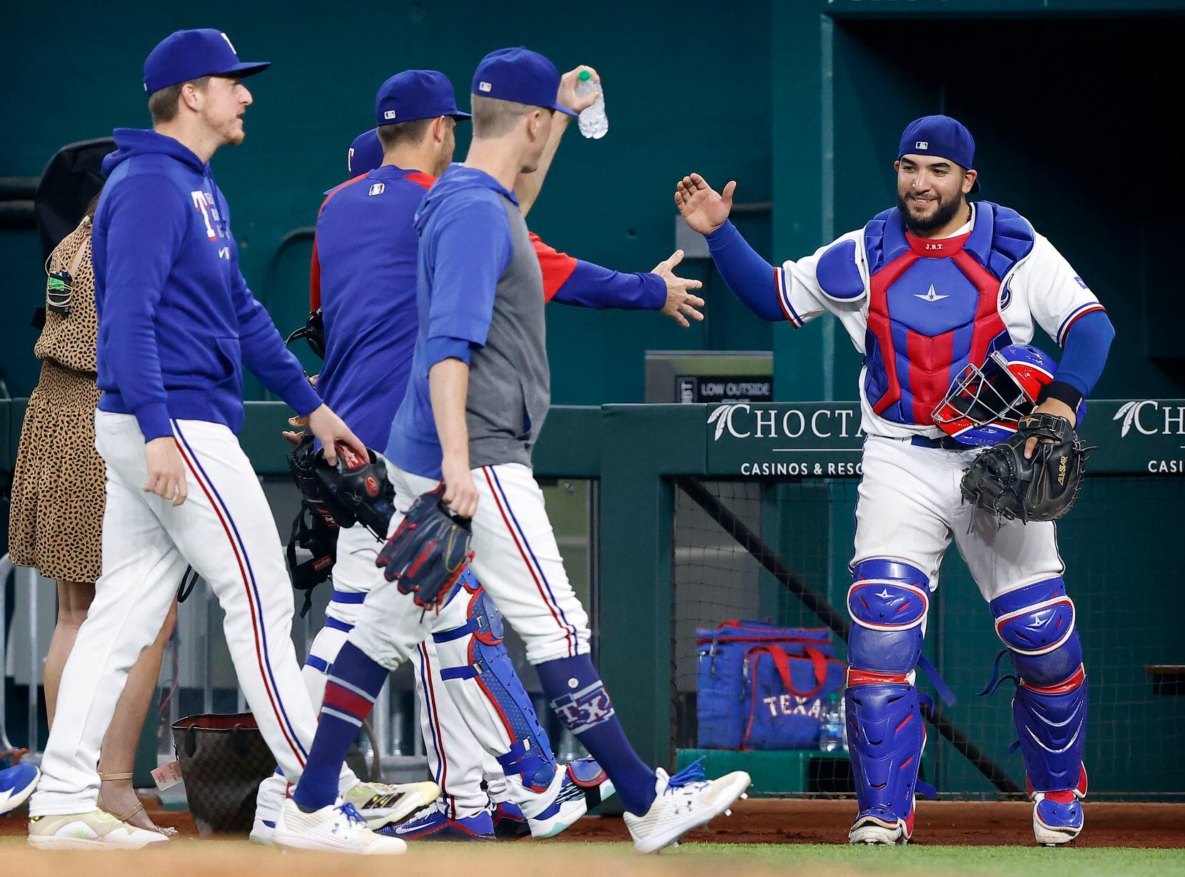 Texas Rangers catcher Jose Trevino (right) is congratulated by the bullpen pitchers after...