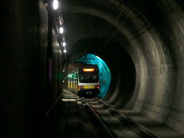A DART train bound for Dallas-Fort Worth International Airport passes through a tunnel near...