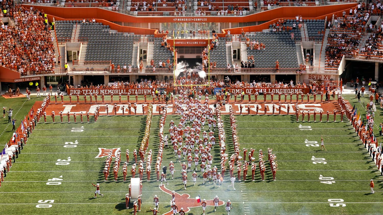 The Texas Longhorns football team races onto the newly named Campbell-Williams Field through the head of a longhorn at DKR-Texas Memorial Stadium, Saturday, September 4, 2021.