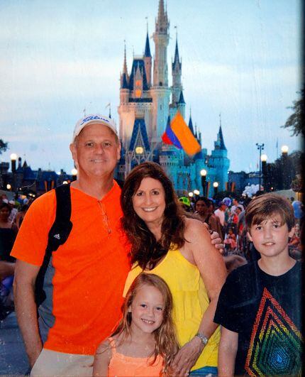 In this 2014 photo taken at Walt Disney World, Cathy and Mark Speed are pictured with their...