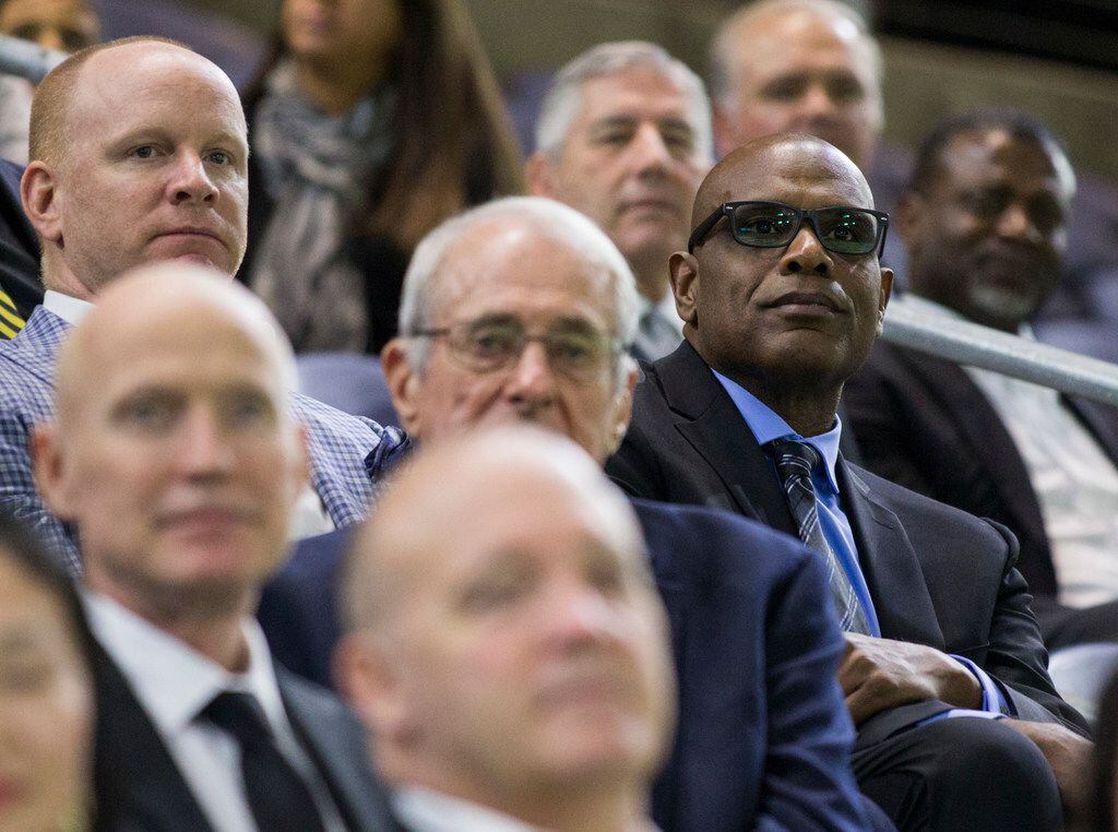 Former University of Iowa football player Malcolm Christie (right) sits among other former...