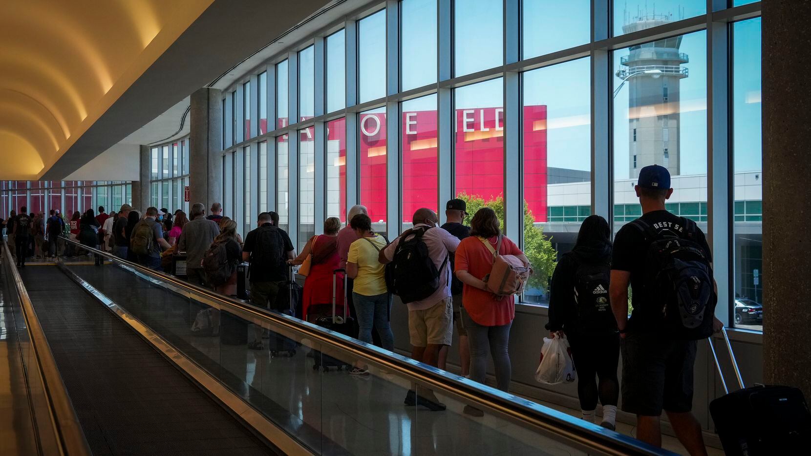 Passengers waited to reenter Dallas Love Field on July 25, 2022. A ground stop was ordered...