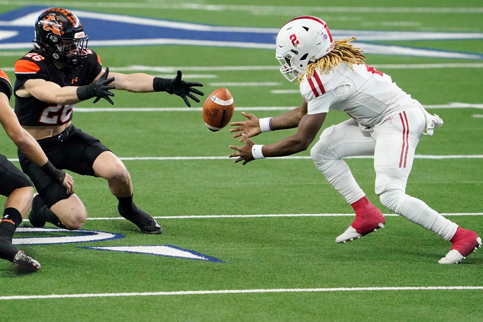 Crosby Deniquez Dunn (2) reaches to recover his own fumble against Aledo Sammy Steffe (26) during the first half of the Class 5A Division II state football championship game at AT&T Stadium on Friday, Jan. 15, 2021, in Arlington. (Smiley N. Pool/The Dallas Morning News)