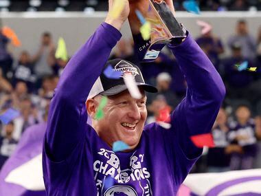 Kansas State Wildcats head coach Chris Klieman raises the Big XII Championship trophy after...