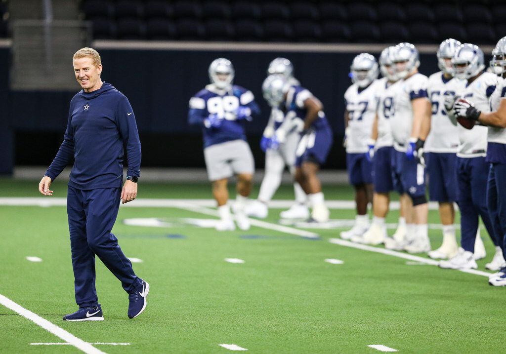 Dallas Cowboys head coach Jason Garrett warms up with the team during a Cowboys practice...