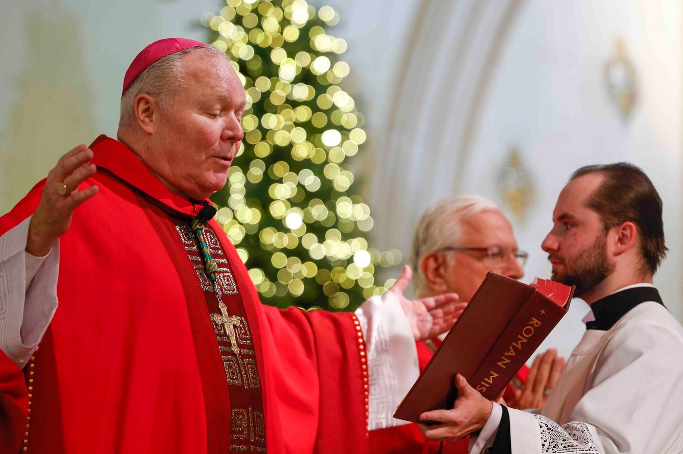 Bishop Edward J. Burns reads from the Roman Missal during a memorial mass for late Pope...
