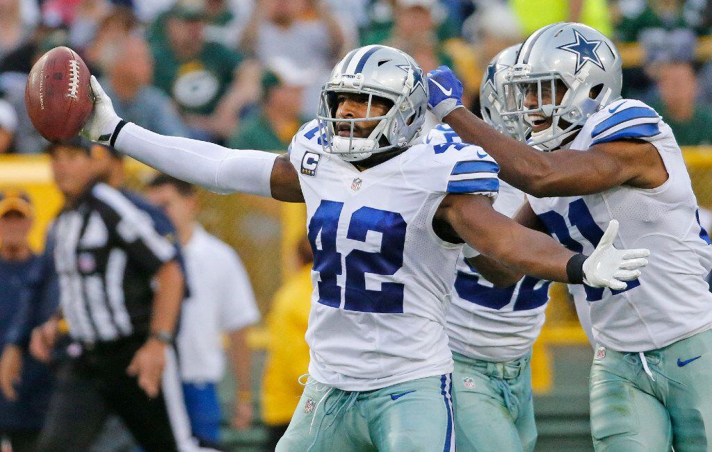 Dallas Cowboys strong safety Barry Church (42) celebrates his interception with teammates...