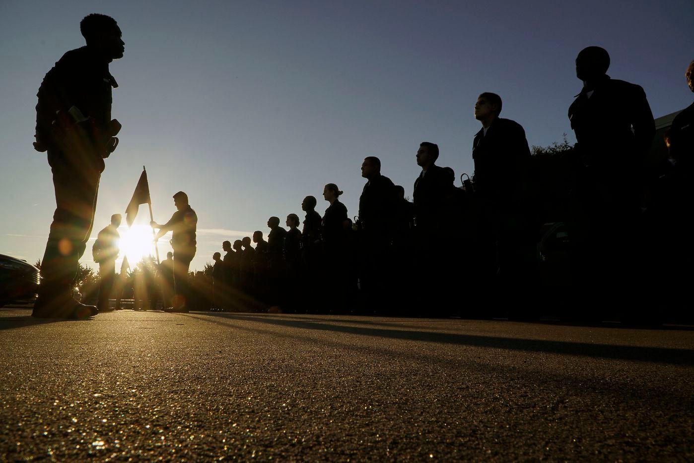 Dallas police recruits stand in formation during morning detail outside the Dallas police...