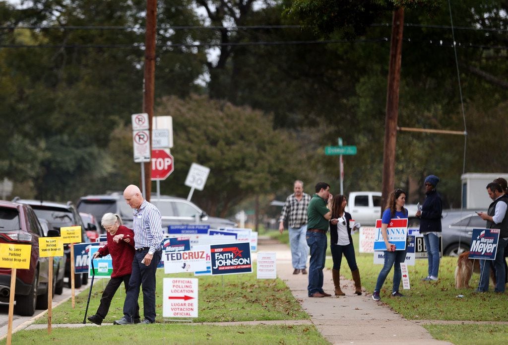 Voters leave the polling station at Geneva Heights Elementary School in Dallas on election...