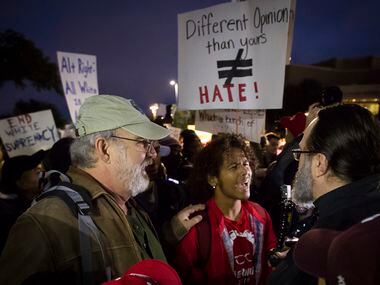 Steven Anderson (center), who was opposed to speaker Richard Spencer, argued with one of...