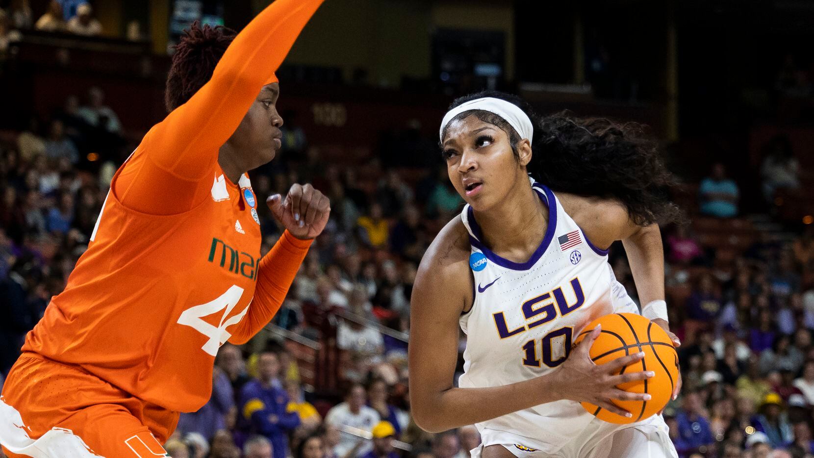 LSU's Angel Reese (10) goes up to shoot over Miami's Kyla Oldacre (44) in the first half of...