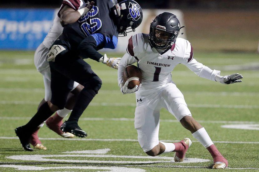 Mansfield Timberview running back Stacy Sneed (1) looks for room to run against Mansfield...