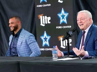 Dallas Cowboys owner Jerry Jones speaks about the signing of quarterback Dak Prescott (left) who laughs during his press conference at The Star in Frisco, Texas, Wednesday, March 10, 2021.