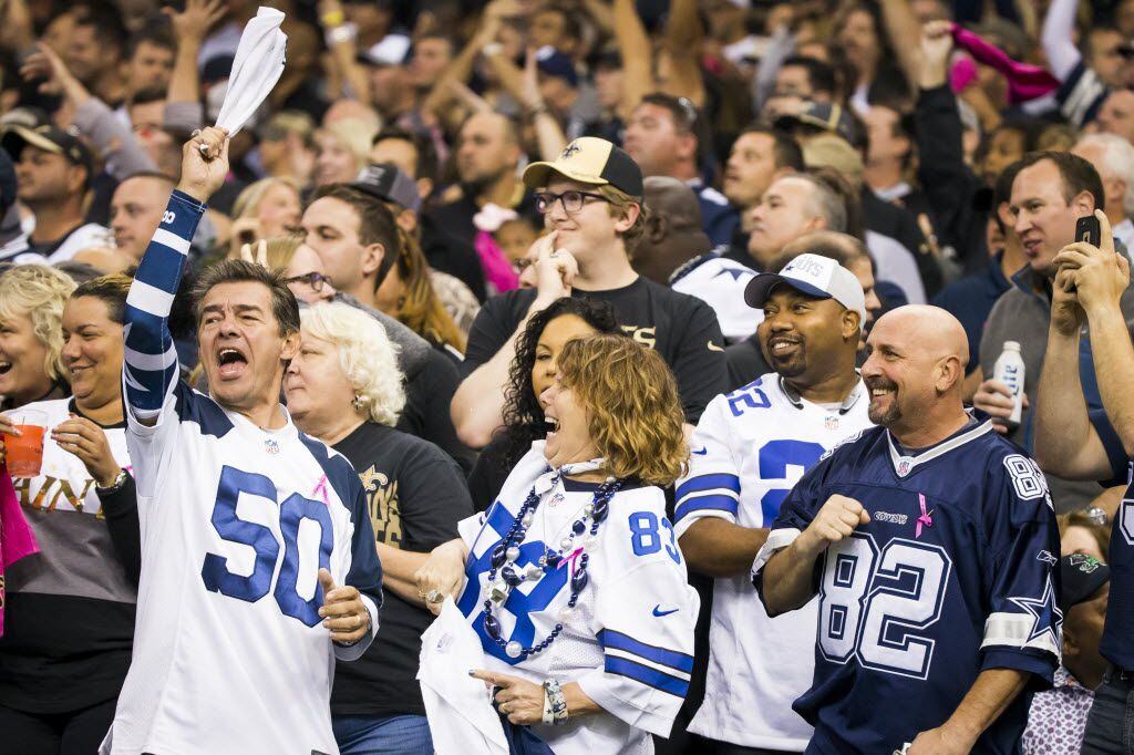 FILE - Dallas Cowboys fans cheer a first down run during the first half of an NFL football...