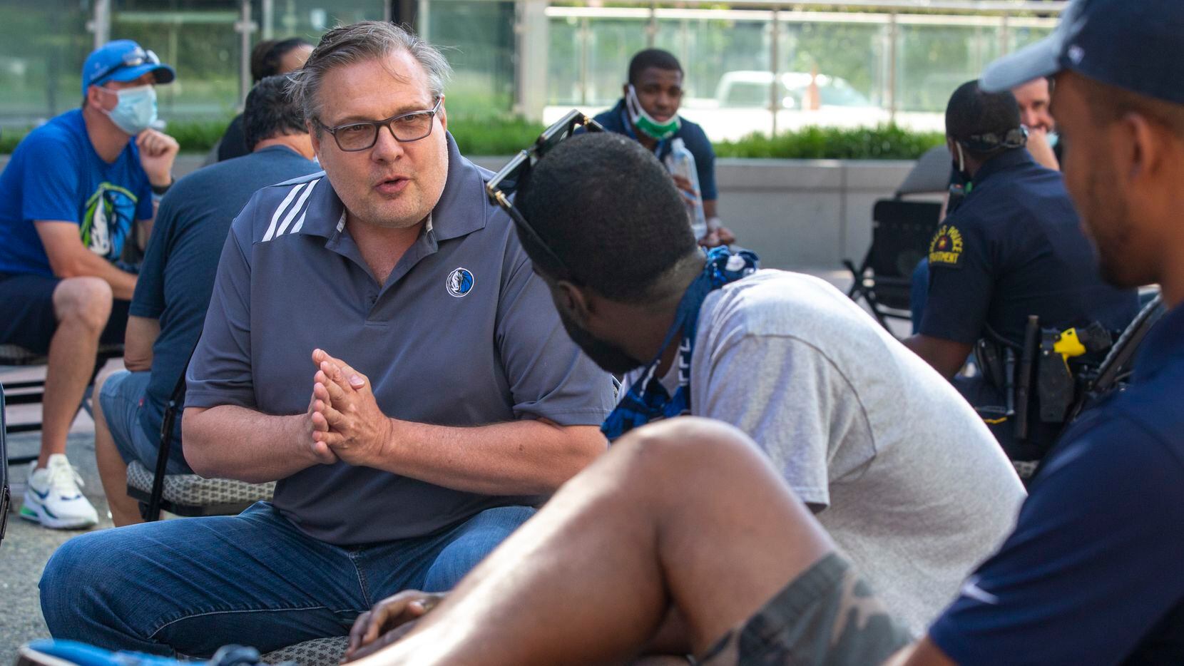 Dallas Mavericks General Manager Donnie Nelson speaks with other members of a small group...