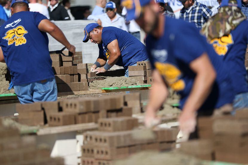 An Artisan Masonry Incorporated mason lays a brick while competing in the North Texas Spec...