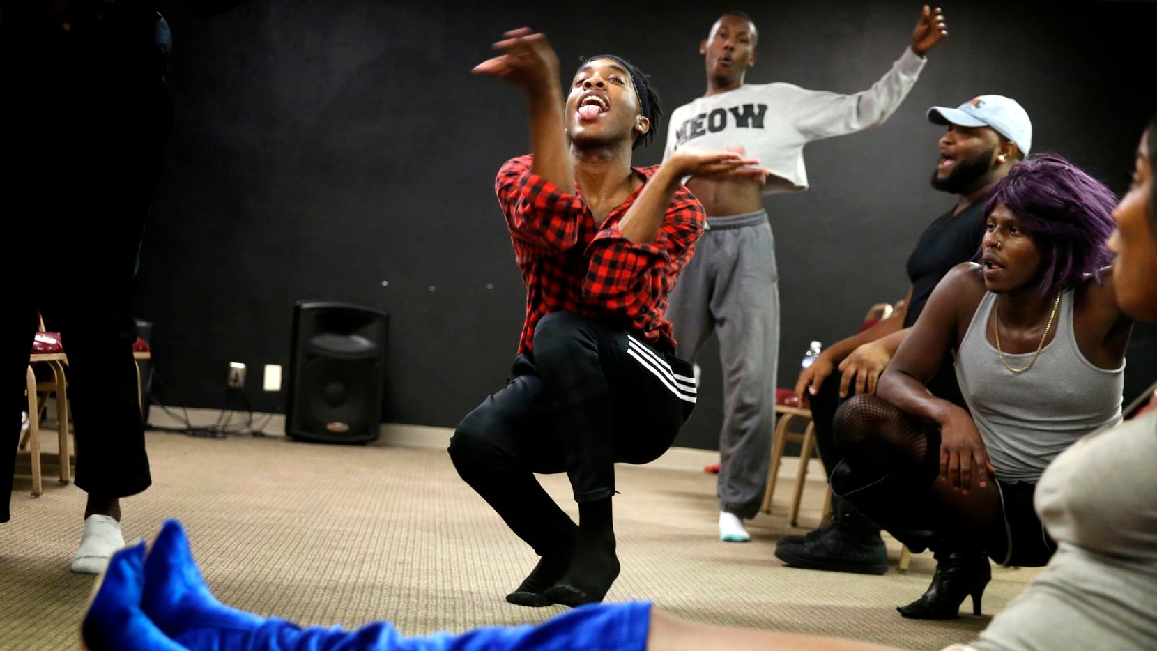 Leondrae Frank (center) vogues with others during a voguing practice at United Black Ellument in Dallas on Aug. 10, 2018. (Rose Baca/The Dallas Morning News)
