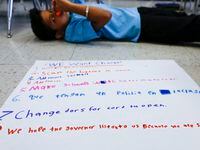 Carlos Hernandez, 10, lays by his poster boards with ideas to make schools safer after the...