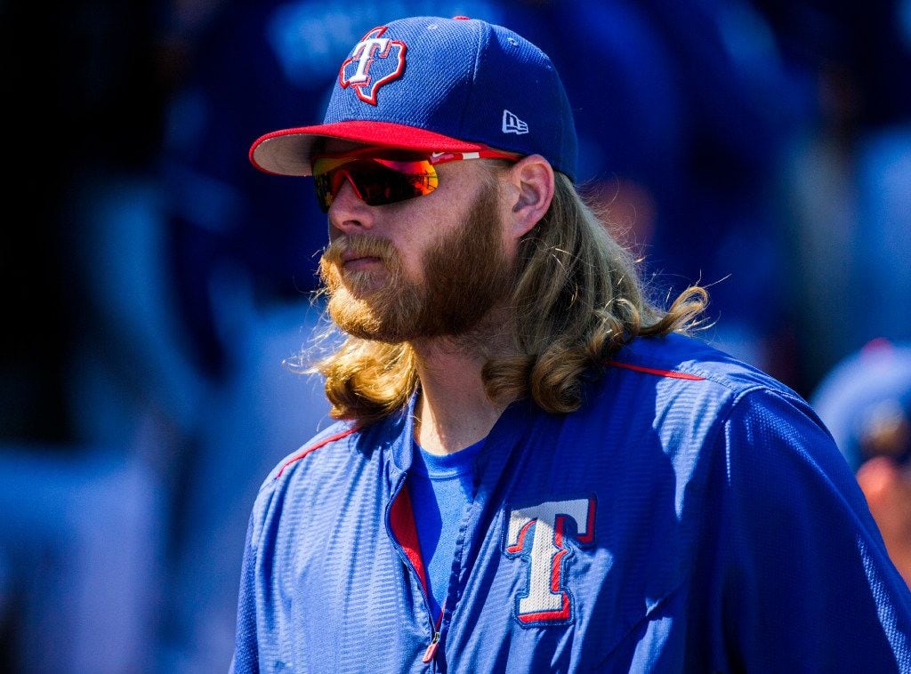 Texas Rangers starting pitcher A.J. Griffin (64) walks through the dugout before a spring...