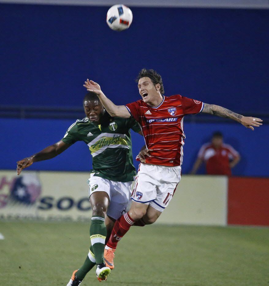FC Dallas Zach Loyd (17) heads the ball  over Portland's Fanendo Adi (9(in the first half at...