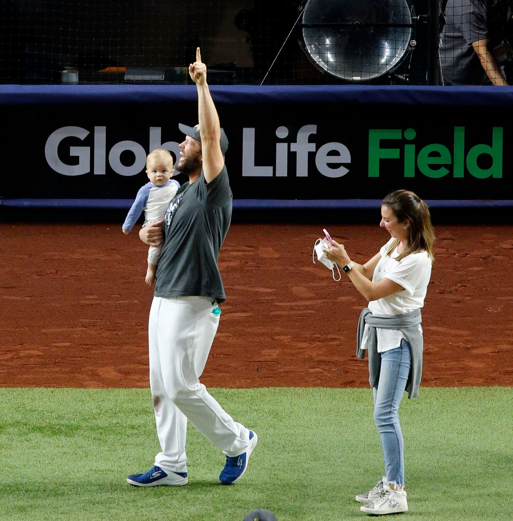 Los Angeles Dodgers starting pitcher Clayton Kershaw waves to fans behind home plate as he...