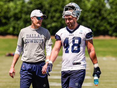 Dallas Cowboys offensive line coach Joe Philbin with tight end (48) Jake Ferguson as they...