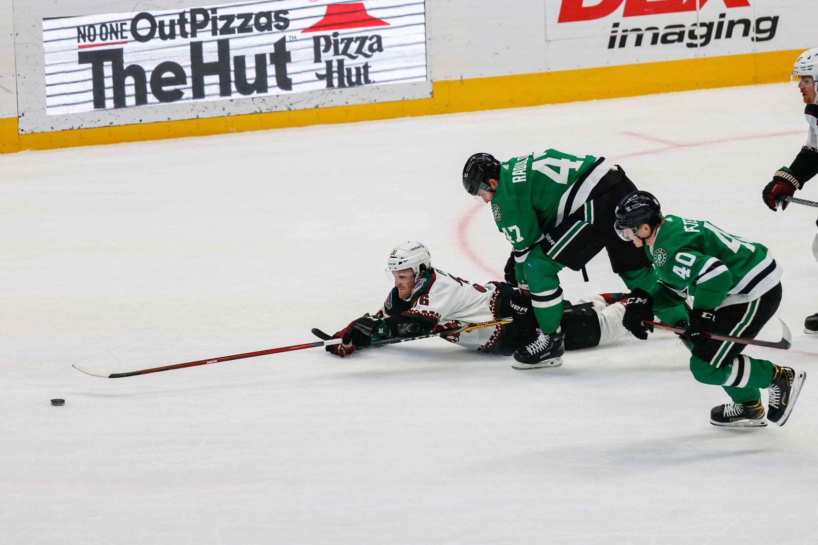 Arizona Coyotes right wing Christian Fischer (36) tries to recover the puck along with Dallas Stars right wing Alexander Radulov (47) and center Jacob Peterson (40) during second period at the American Airlines Center in Dallas on Monday, December 6, 2021. (Lola Gomez/The Dallas Morning News)