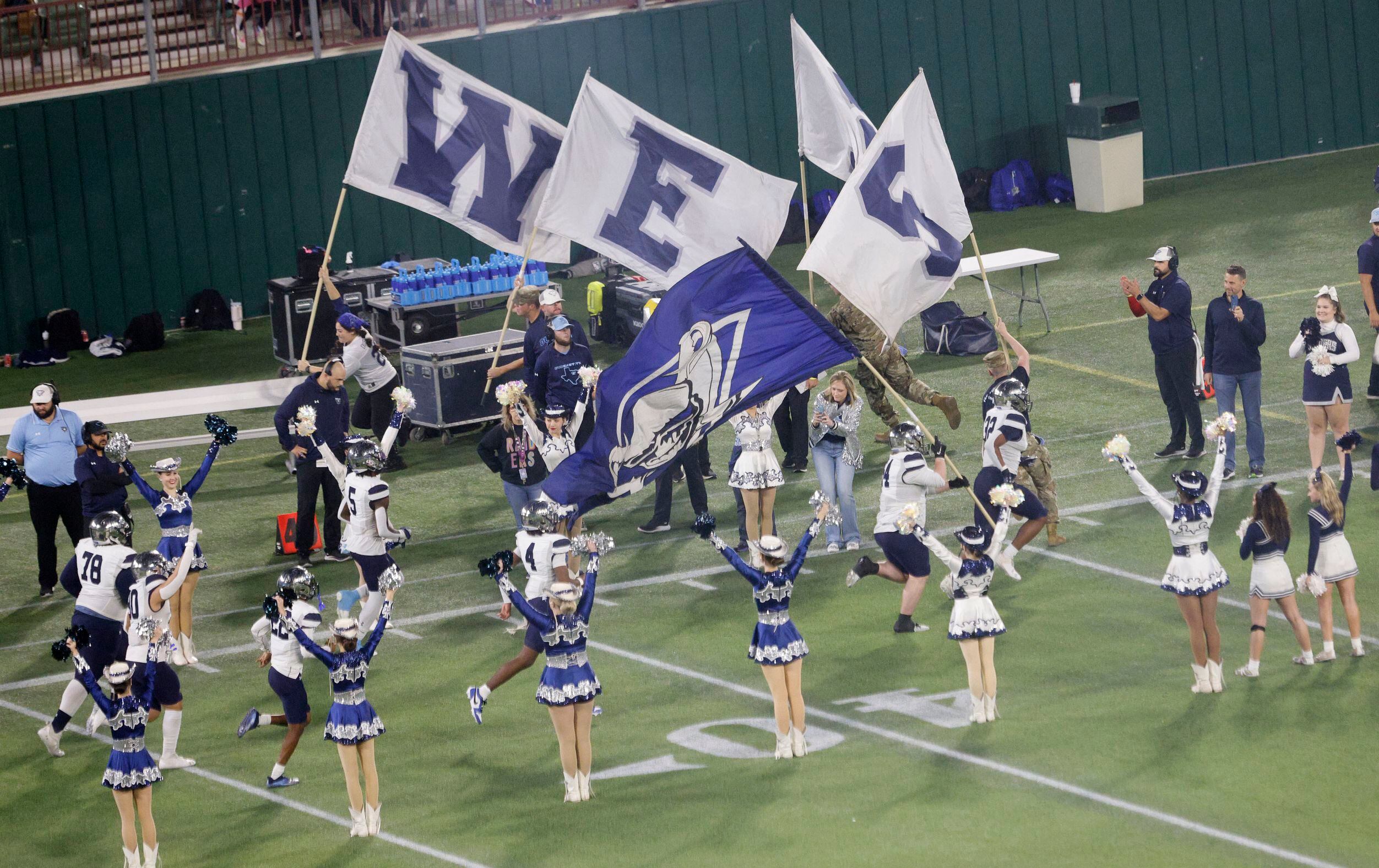 Wylie East  players run out into the field before the first half of a Class 6A Division II...