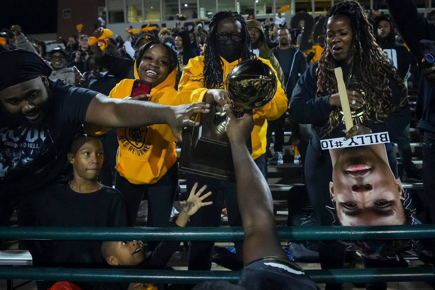 South Oak Cliff running back Qualon Farrar hands the game trophy into the stands after a...