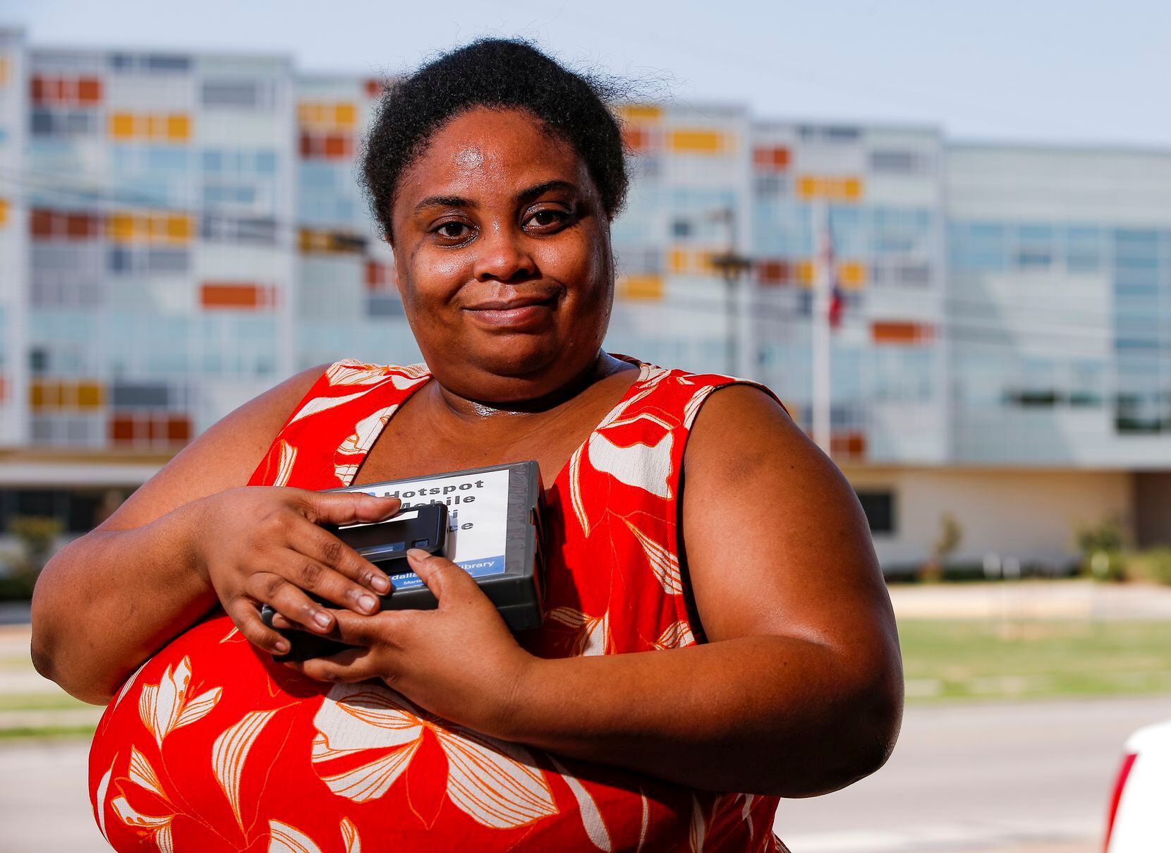 Qiana Vance, a UNT Dallas public health major, poses for a photo with the mobile hotspot she...
