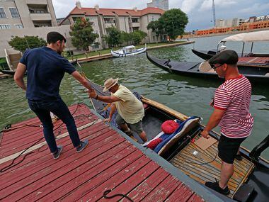 Dallas Morning News reporter Brendan Meyer, left, helps reader Ayhan Calis get off a gondola.