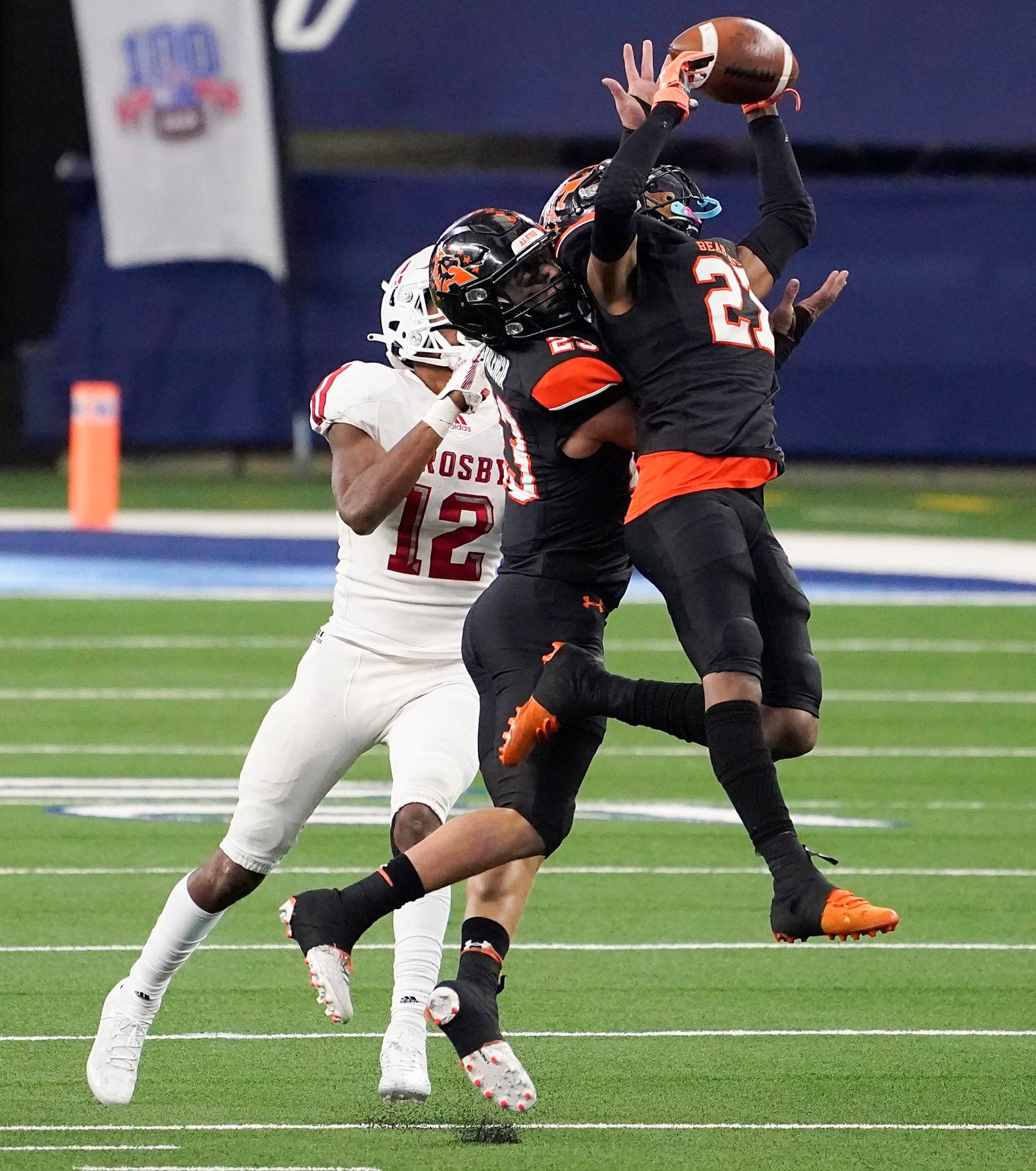 Aledo defenders Jaden Allen (27) and Elijah Valencia (23) break up a pass intended for Crosby wide receiver Jaylen Herman (12) during the second half of a 56-21 victory over Crosby to win the Class 5A Division II state football championship game at AT&T Stadium on Friday, Jan. 15, 2021, in Arlington. The victory gave the Bearcats the 10th state championship in school history. (Smiley N. Pool/The Dallas Morning News)