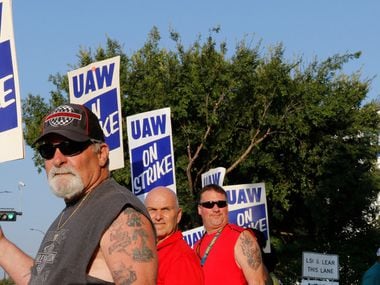 Retired GM worker Jeff Adler, left, came out to picket with other General Motors Assembly Plant workers on the picket lines early Monday morning, September 16, 2019, at the GM plant in Arlington, Texas.