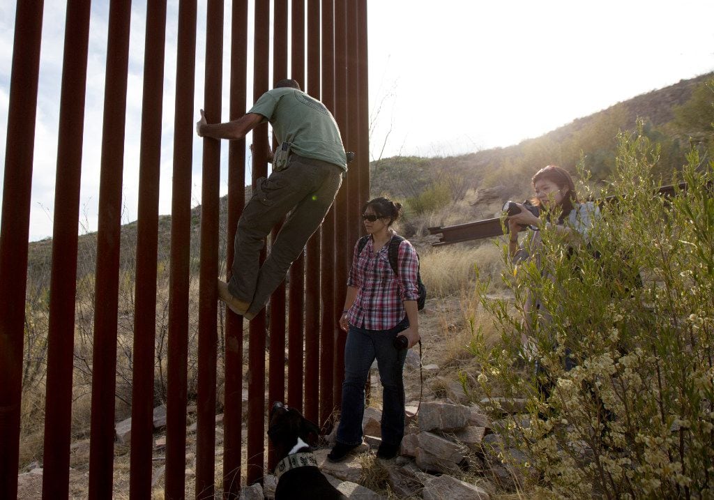 In this May 11, 2016, file photo, Tim Foley shows how to climb a section of the border wall...