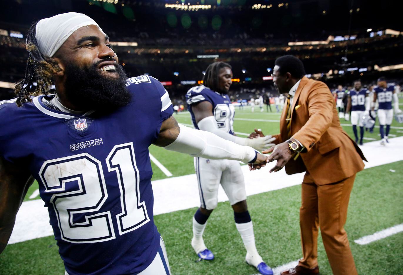 Dallas Cowboys running back Ezekiel Elliott (21) is congratulated on their win by former...