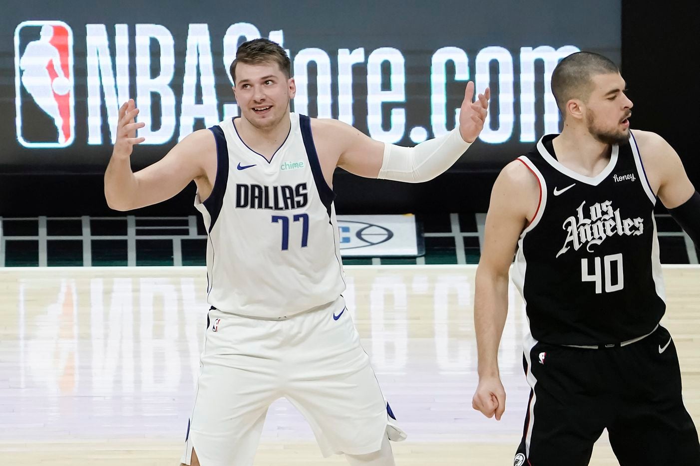 Dallas Mavericks guard Luka Doncic reacts after making a 3-pointer as LA Clippers center...