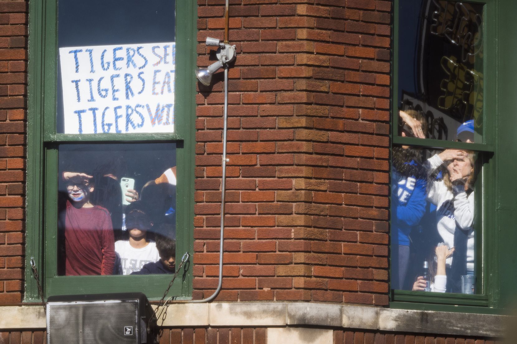 Fans looks out second floor windows to watch a ESPN College GameDay on Beale Street before...