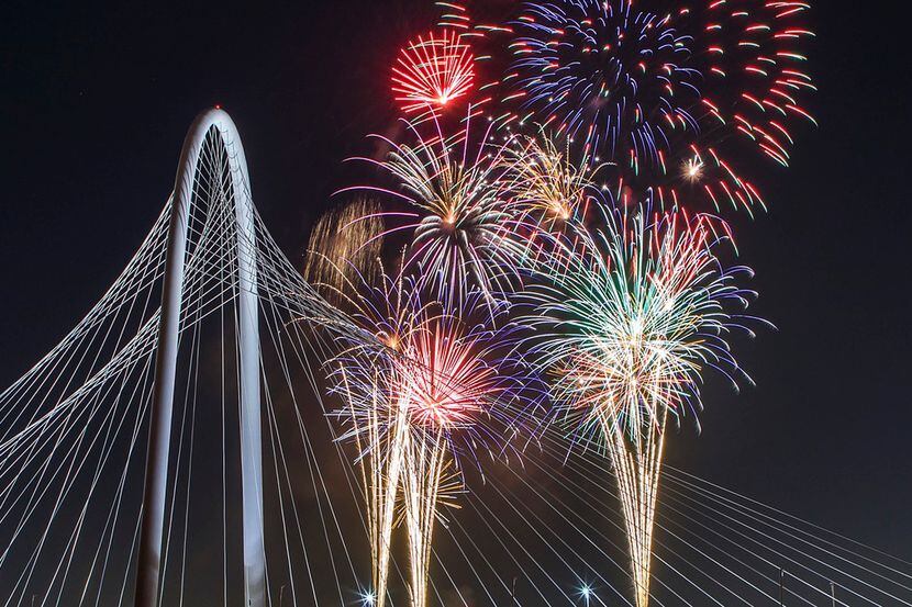 Fireworks explode over the Margaret Hunt Hill Bridge during the Red, White, and Boom on the...