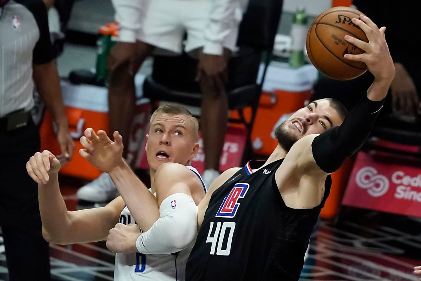 LA Clippers center Ivica Zubac (40) grabs a rebound from Dallas Mavericks center Kristaps Porzingis (6) during the first half of an NBA playoff basketball game at Staples Center on Tuesday, May 25, 2021, in Los Angeles.