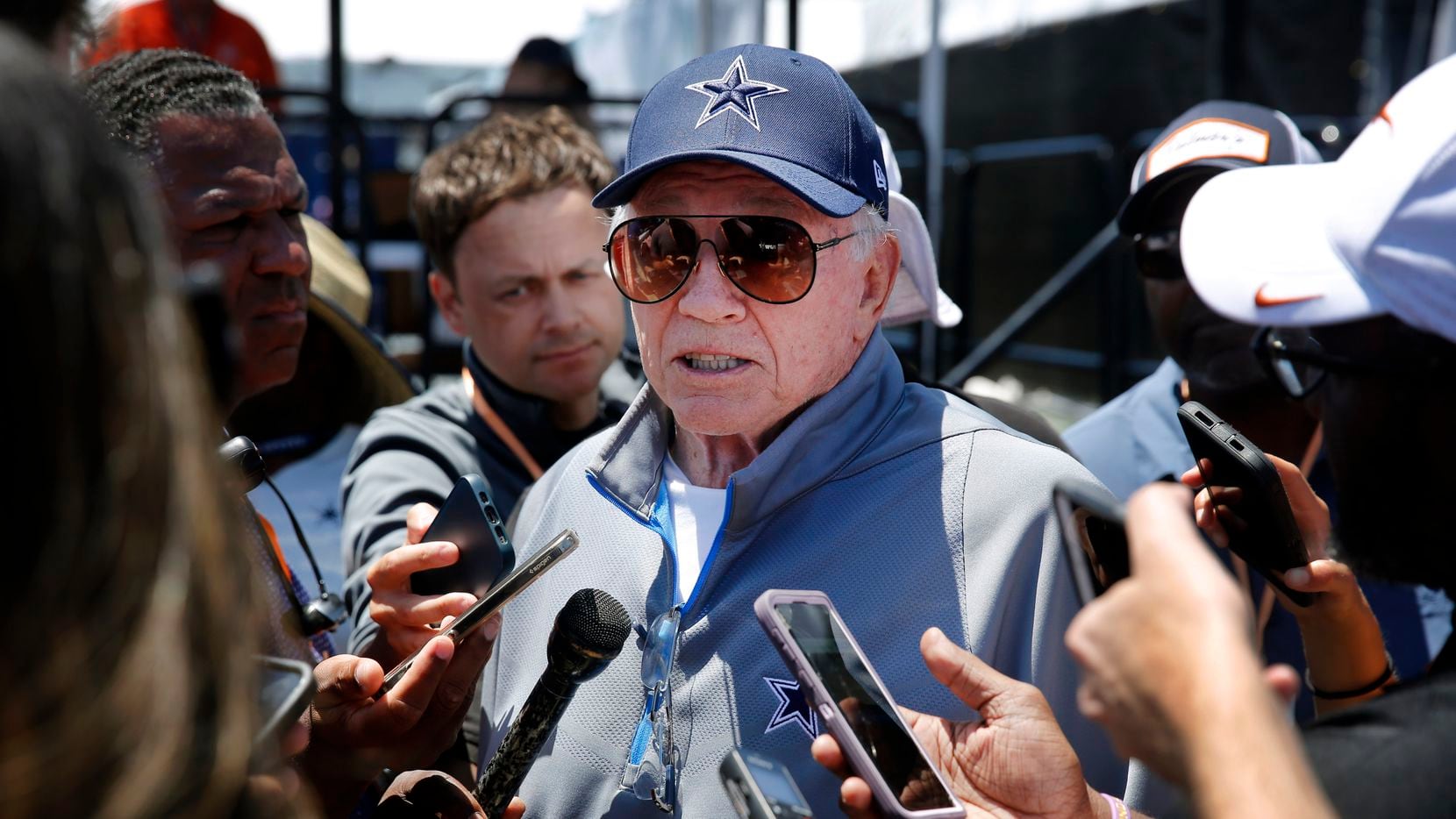 Dallas Cowboys owner Jerry Jones visits with media following training camp practice in...