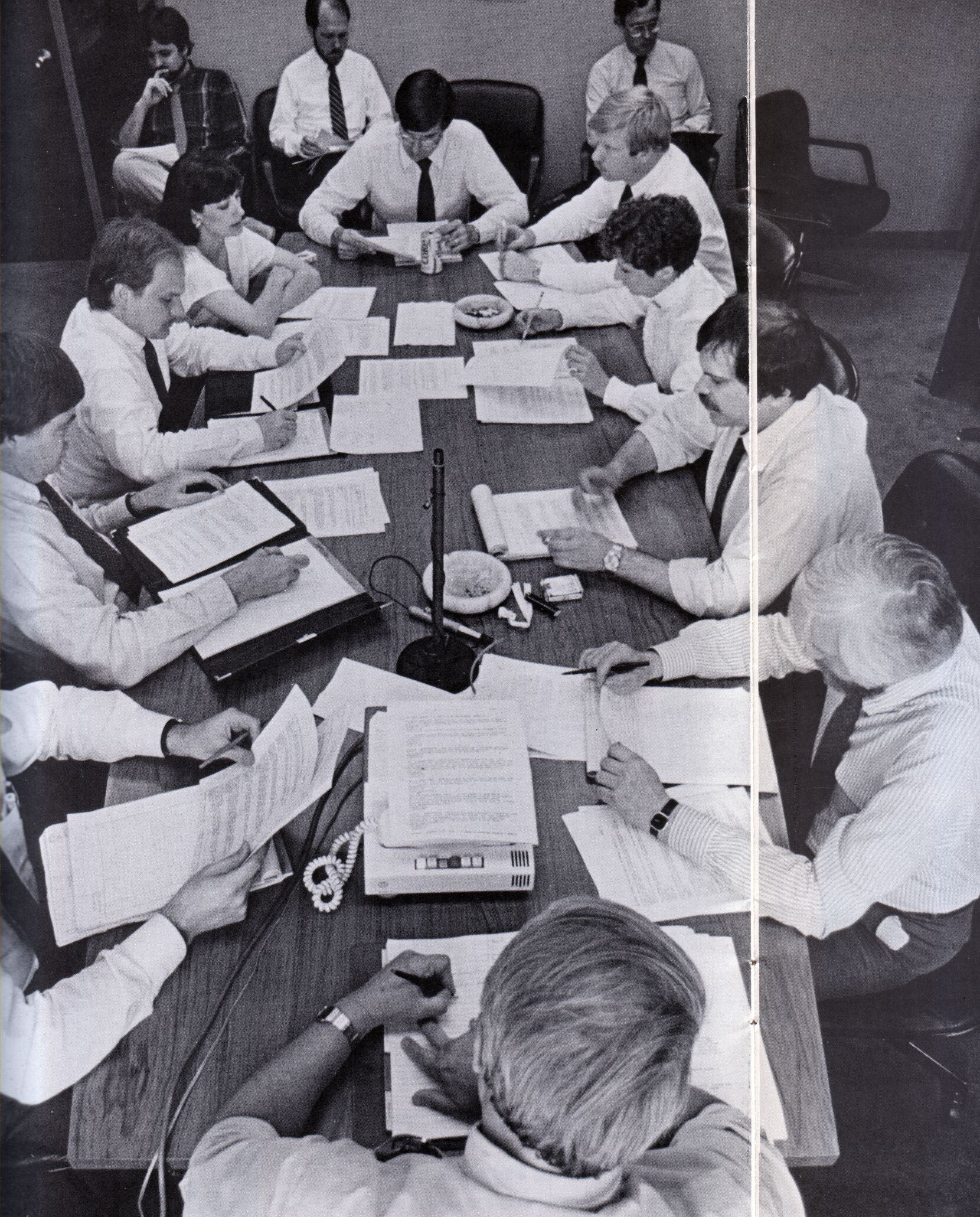 In 1985, Dallas Morning News editors were shown gathering at the daily 3 p.m. "budget" meeting. Ralph Langer is on the far right along the back wall.