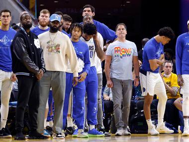 Dallas Mavericks owner Mark Cuban and his team watch as the Golden State Warriors hold the...