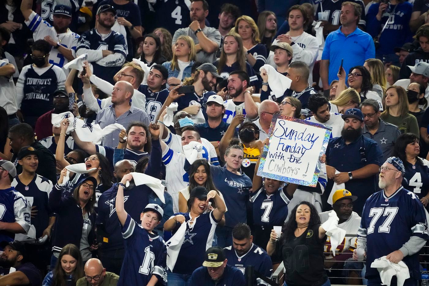 Dallas Cowboys fans cheer a touchdown by tight end Dalton Schultz during the first half of an NFL football game against the Washington Football Team at AT&T Stadium on Sunday, Dec. 26, 2021, in Arlington.