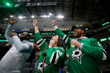 (From left) Michael Aalonia, April McEuen, and David Brooks, all from Dallas, cheer a...