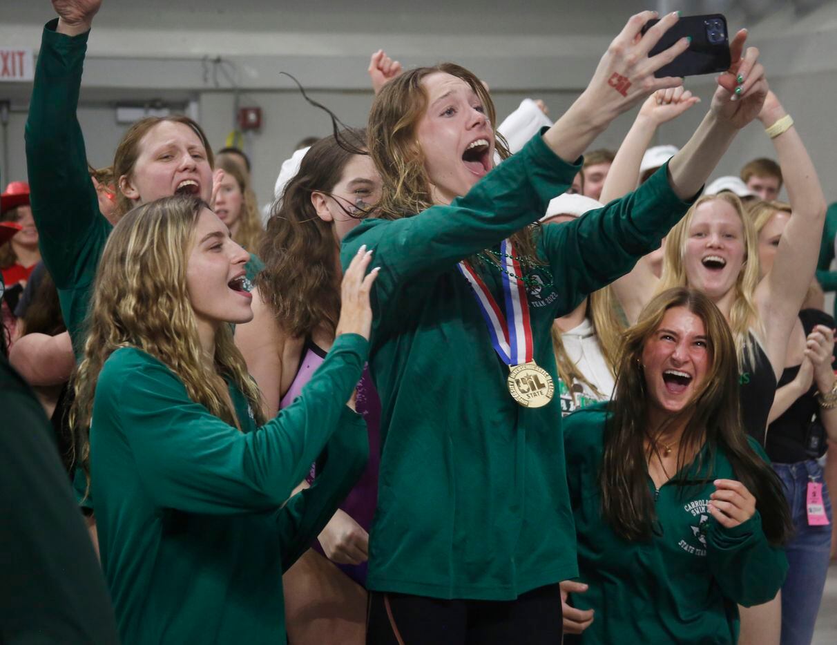 Members of the Southlake Carroll girls swim and dive team revel in the moment after...
