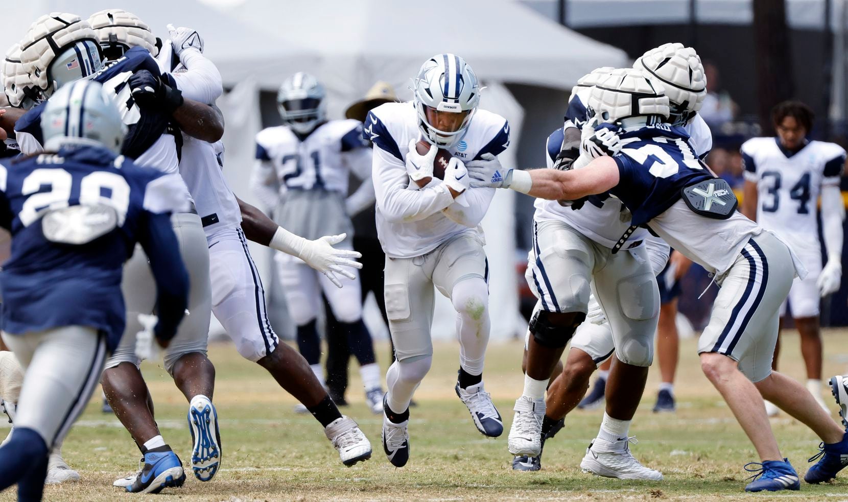 Dallas Cowboys running back Tony Pollard (20) finds a hole in the defensive line during a...