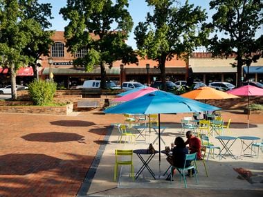 People find shade from the sun in Garland City Square in downtown Garland, Texas, Friday, June 26, 2020.